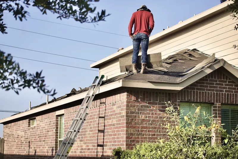 Professional roofer working on a residential roof in Adobe Highlands